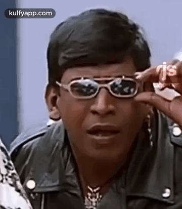 A Man Wearing Sunglasses And A Leather Jacket . GIF