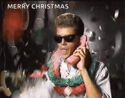 A Man Wearing Sunglasses And A Lei Is Talking On A Pink Telephone . GIF
