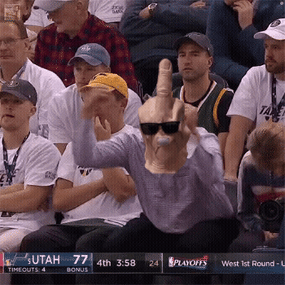 A Man Wearing Sunglasses And A Mask Giving The Middle Finger At A Basketball Game GIF