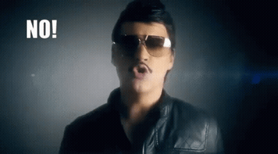 A Man Wearing Sunglasses And A Mustache Is Singing A Song In A Dark Room . GIF