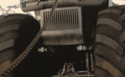 A Man Wearing Sunglasses And A Necklace Is Smiling GIF