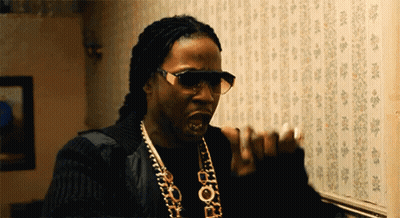 A Man Wearing Sunglasses And A Necklace That Says Pop GIF