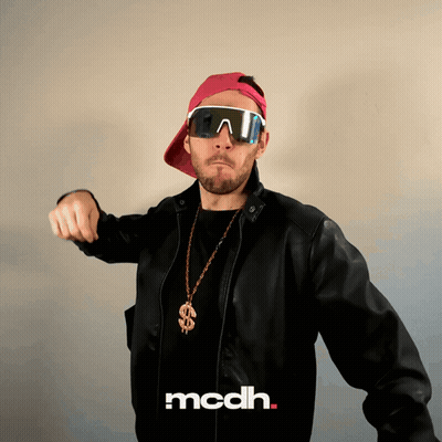 A Man Wearing Sunglasses And A Necklace With A Dollar Sign Says Mcdh On The Bottom GIF