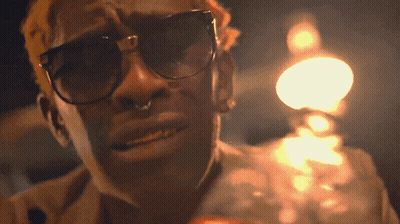A Man Wearing Sunglasses And A Nose Ring GIF