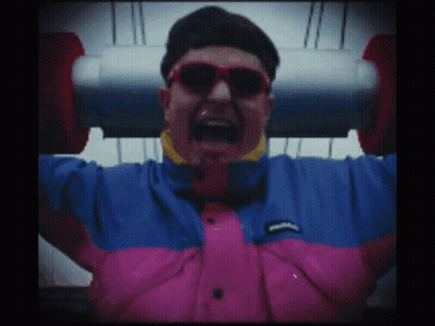 A Man Wearing Sunglasses And A Pink And Blue Jacket GIF
