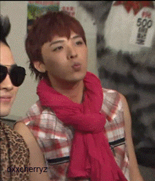 A Man Wearing Sunglasses And A Pink Scarf Has The Name Oxxcherryz On The Bottom GIF