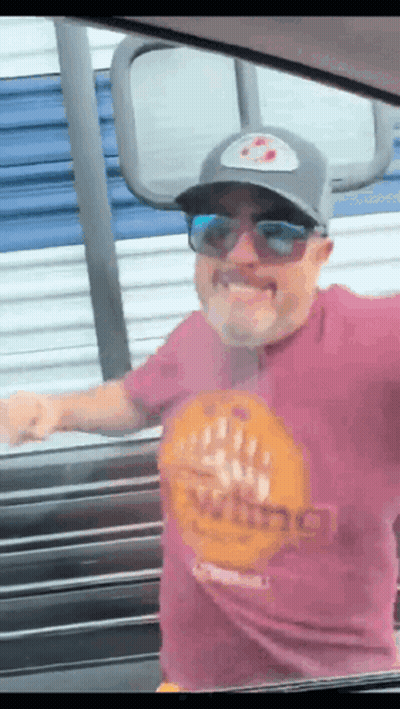 A Man Wearing Sunglasses And A Purple Shirt That Says Viking GIF