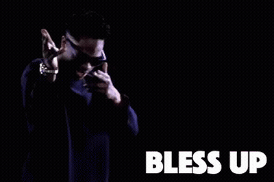 A Man Wearing Sunglasses And A Purple Sweater Is Dancing In A Dark Room With The Words Bless Up . GIF