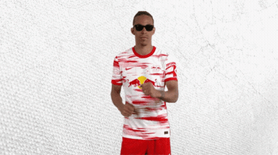 A Man Wearing Sunglasses And A Red And White Jersey With A Red Bull On It GIF