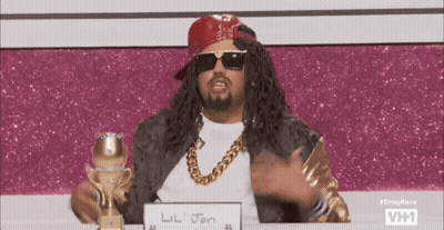 A Man Wearing Sunglasses And A Red Bandana Is Holding A Trophy And A Sign That Says Lil Jon GIF