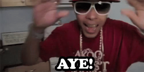 A Man Wearing Sunglasses And A Red Shirt Says Aye . GIF