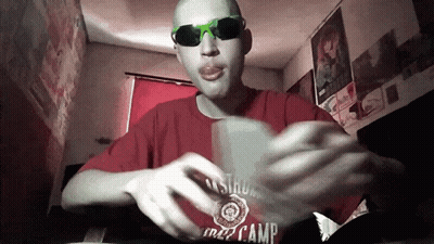 A Man Wearing Sunglasses And A Red Shirt That Says Camp On It GIF