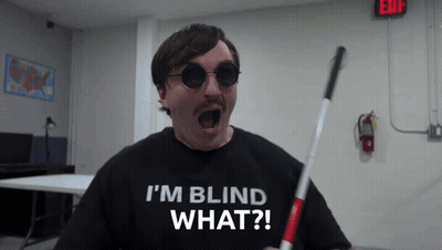 A Man Wearing Sunglasses And A Shirt That Says " I 'M Blind What " GIF