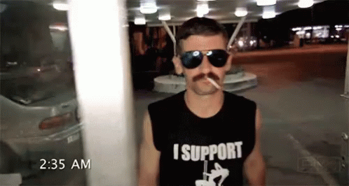 A Man Wearing Sunglasses And A Shirt That Says I Support Smoking A Cigarette GIF