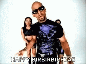 A Man Wearing Sunglasses And A Skull Shirt Says Happy Birbirbirfdae In Front Of Two Women GIF