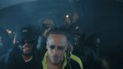A Man Wearing Sunglasses And A Stussy Hat GIF