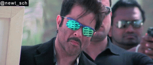 A Man Wearing Sunglasses And A Suit Has The Name Newt Sch On The Bottom GIF