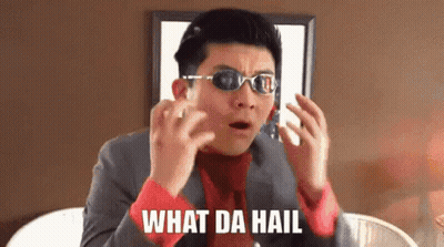 A Man Wearing Sunglasses And A Suit Is Making A Funny Face And Says What Da Hail . GIF