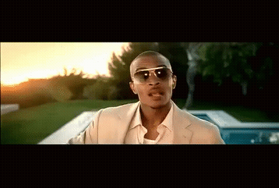 A Man Wearing Sunglasses And A Tan Suit Stands In Front Of A Pool GIF