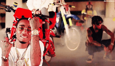 A Man Wearing Sunglasses And A Watch Is Giving The Middle Finger In Front Of Motorcycles . GIF