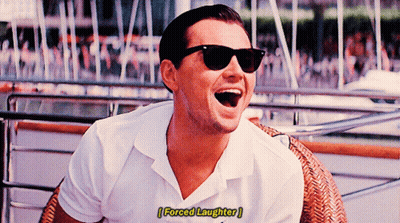A Man Wearing Sunglasses And A White Shirt Is Laughing With The Words Forced Laughter Below Him GIF