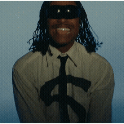 A Man Wearing Sunglasses And A White Shirt With A Dollar Sign On It GIF