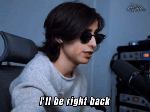 A Man Wearing Sunglasses And A White Sweater Says I 'Ll Be Right Back GIF
