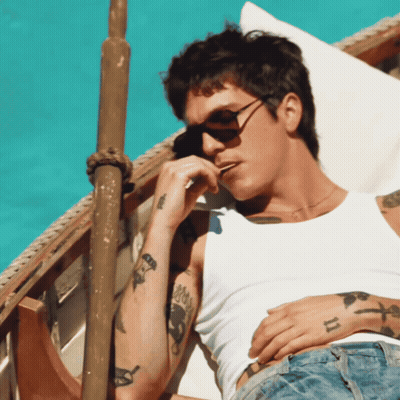 A Man Wearing Sunglasses And A White Tank Top Has A Tattoo On His Arm That Says ' Ii ' GIF