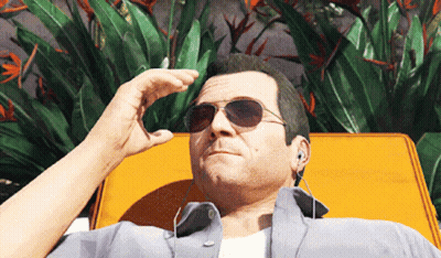A Man Wearing Sunglasses And Earbuds Is Laying On A Yellow Chair GIF