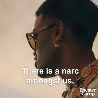 A Man Wearing Sunglasses And Earrings Says There Is A Narciss Amongst Us GIF