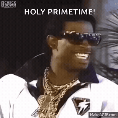 A Man Wearing Sunglasses And Gold Chains Is Smiling And Saying Holy Primetime GIF