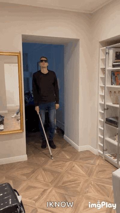 A Man Wearing Sunglasses And Holding A Cane In A Hallway With The Words Iknow Below Him GIF
