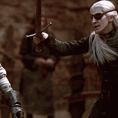 A Man Wearing Sunglasses And Holding A Sword In His Hand GIF