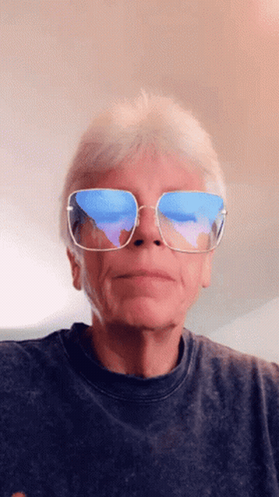 A Man Wearing Sunglasses Has A Reflection Of The Ocean In His Lenses GIF