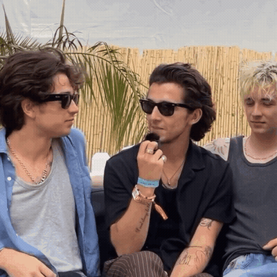 A Man Wearing Sunglasses Has A Tattoo On His Arm That Says " I 'M A Bitch " GIF