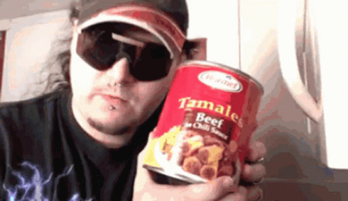A Man Wearing Sunglasses Holds A Can Of Tamales Beef In Chili Sauce GIF