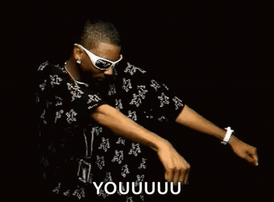 A Man Wearing Sunglasses Is Dancing In A Dark Room . GIF