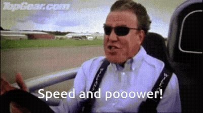 A Man Wearing Sunglasses Is Driving A Car And Says Speed And Pooower . GIF