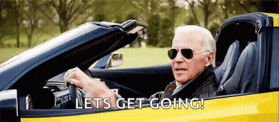 A Man Wearing Sunglasses Is Driving A Yellow Sports Car And Says Let 'S Get Going ! GIF