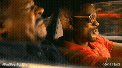 A Man Wearing Sunglasses Is Driving Another Man In A Car With The Hashtag #Badboysforlife GIF
