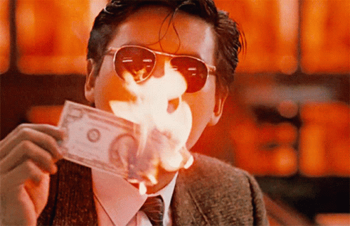 A Man Wearing Sunglasses Is Holding A 20 Dollar Bill In His Mouth GIF