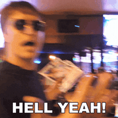 A Man Wearing Sunglasses Is Holding A Box Of Money And Says Hell Yeah GIF