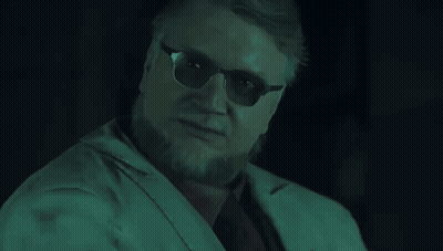 A Man Wearing Sunglasses Is Holding Two Stuffed Animals On His Fingers GIF