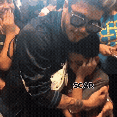 A Man Wearing Sunglasses Is Hugging A Little Boy With The Word Scar Written On The Bottom GIF