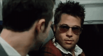 A Man Wearing Sunglasses Is Looking At Another Man GIF