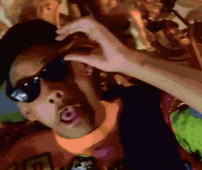 A Man Wearing Sunglasses Is Making A Heart Shape With His Hands GIF