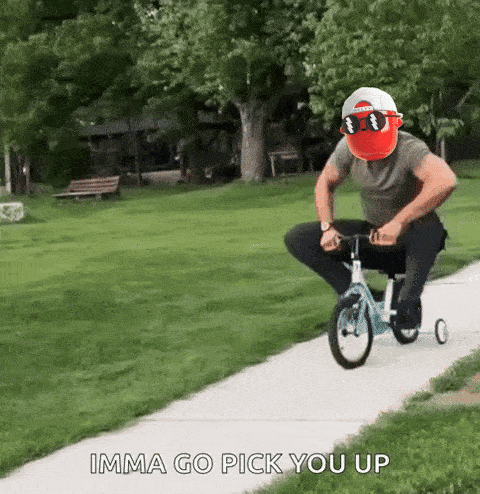 A Man Wearing Sunglasses Is Riding A Tricycle Down A Sidewalk With The Words Imma Go Pick You Up Below Him GIF