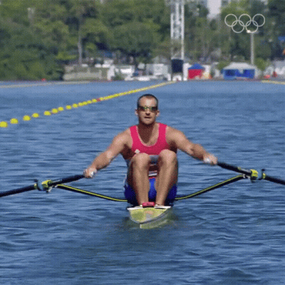 A Man Wearing Sunglasses Is Rowing A Boat In The Water GIF