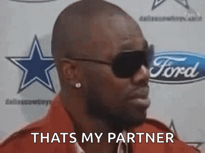 A Man Wearing Sunglasses Is Saying `` That 'S My Partner '' In Front Of A Ford Logo . GIF