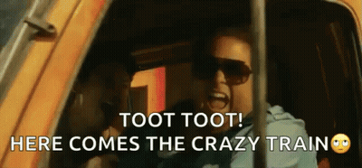 A Man Wearing Sunglasses Is Screaming In A Car With The Words Toot Toot Here Comes The Crazy Train GIF